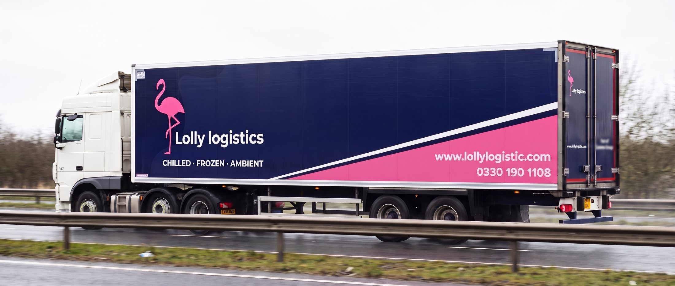A Lolly Logistics refrigerated trailer on a British dual carriageway